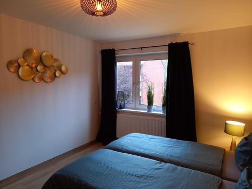 Schlafzimmer mit einem Bett und einem Fenster in der Unterkunft Ems Apartment in Emden