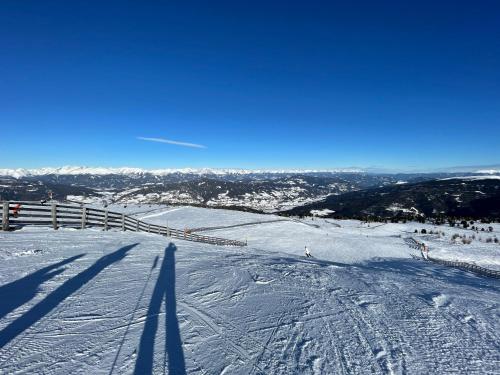 a snow covered slope with people skiing down a hill at Ferienhaus Kreischberg - Silberhirschen Hütte in Sankt Lorenzen ob Murau
