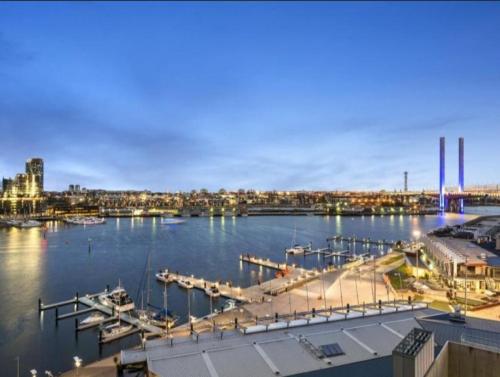 a view of a marina with boats in the water at Lovely waterfront condo with swimming pool and gym in the heart of Docklands in Melbourne