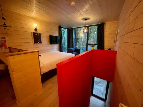 a bedroom with a bed and a red desk in it at The Bauhaus in Jurbise