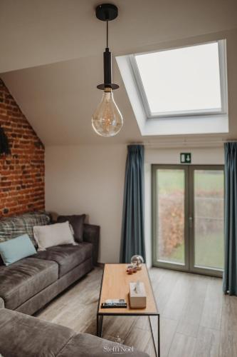 a living room with a couch and a table at Gavershof in Geraardsbergen