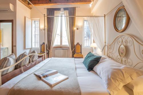 a bedroom with a large bed with a tray on it at Corte Realdi Suites Piazza Erbe in Verona