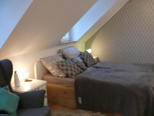 a attic room with a bed and a couch at Landlust Unser L ieblingscafe in Xanten