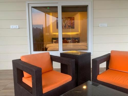 two chairs and a table on a patio at Karinya Villas in Nainital