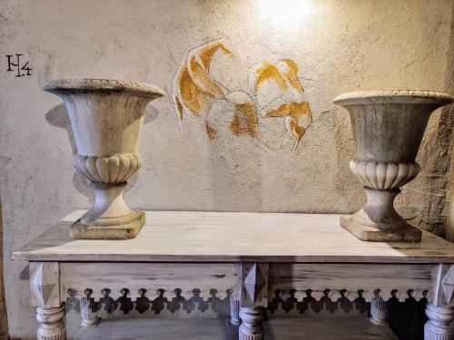 two vases sitting on top of a table at Posada Restaurante Casa de la Sal in Candelario