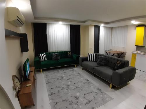 a living room with two couches and a television at Canan Residance in Demre