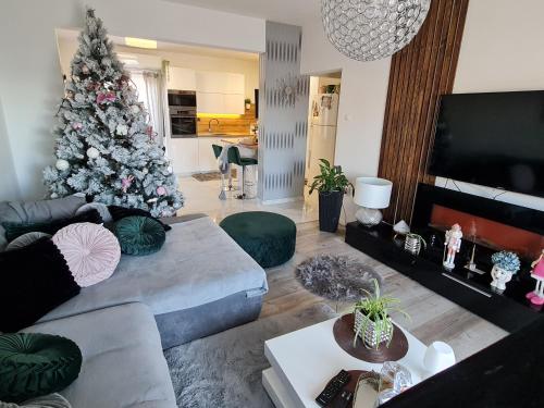 a living room with a christmas tree and a couch at Luxury Apartments Mia in Podstrana