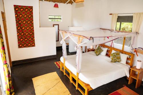 a room with two bunk beds in it at Isunga Lodge in Kibale Forest National Park