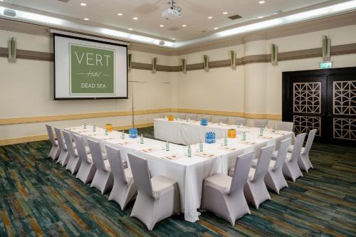 a large conference room with a white table and chairs at Vert Dead Sea by AFI Hotels in Ein Bokek