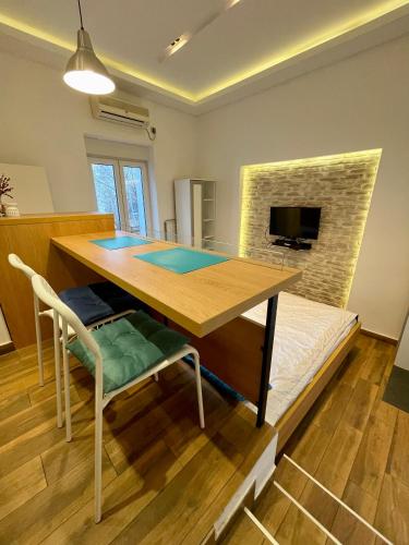 a dining room with a table and a couch at The Bohemian Residence in Belgrade