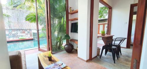 a living room with a view of a pool at Sarina Hotel & Villa in Phnom Penh