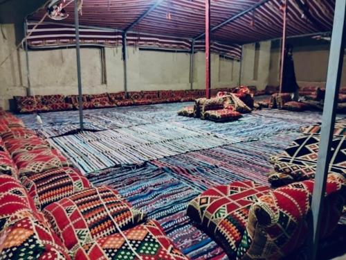 a room filled with lots of rugs on the floor at Aghurmi Siwa Ecolodge & Salt Cave in Siwa