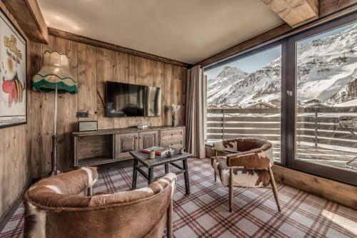 a living room with a view of mountains at Hotel & Spa Le Val d'Isère in Val dʼIsère
