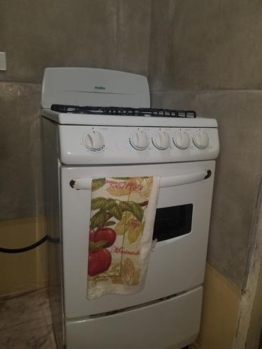 a white stove with a towel hanging on it at Marshan villa in Montego Bay