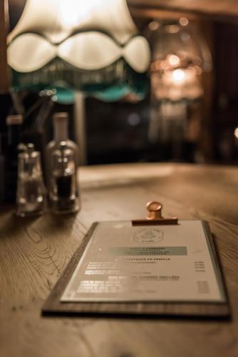 a piece of paper on a table with two bottles at Hotel & Spa Le Val d'Isère in Val dʼIsère