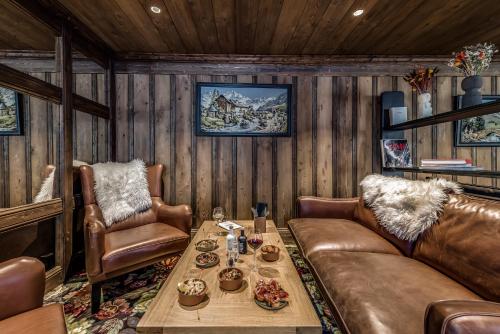 a living room with a couch and a table at Hotel & Spa Le Val d'Isère in Val dʼIsère