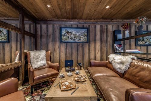 a living room with a couch and a table at Hotel & Spa Le Val d'Isère in Val dʼIsère
