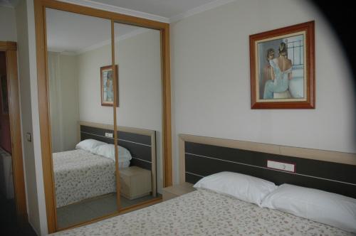 Posteľ alebo postele v izbe v ubytovaní Apartamentos Turisticos Vilagarcía- Rio Ulla