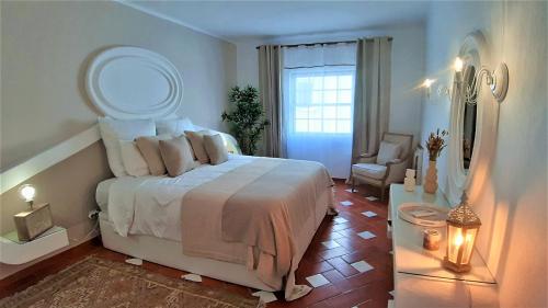 een slaapkamer met een bed met een spiegel en een stoel bij CITY WALLS rooftop terrace duplex @ citycenter & beach in Lagos
