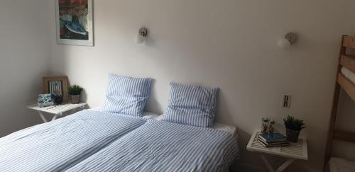 a bedroom with a bed with blue and white stripes at La Maison in Axat