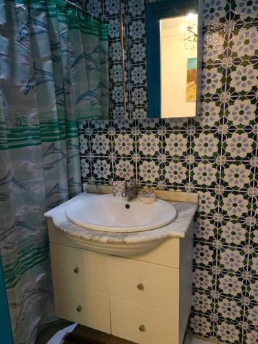 a bathroom with a sink and a mirror at Dar El Kasba Riad Guest House in Bizerte