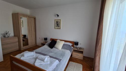 a bedroom with a bed with towels on it at Apartments Solis, 50 m from the sea - Jakišnica in Jakišnica