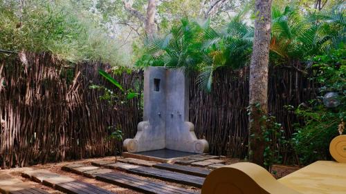 a bird house sitting in front of a fence at Mind Body and Soul in Dambulla
