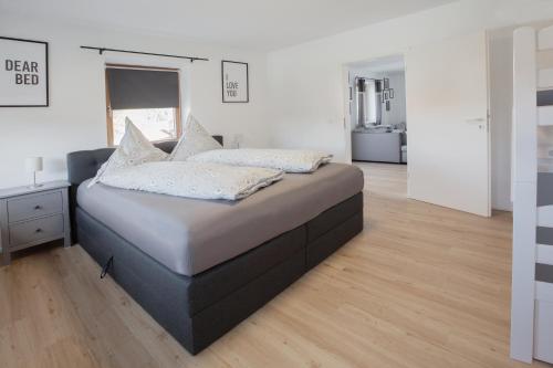 a large bed in a room with white walls at Ferienwohnung zum Traumblick in Pfronten