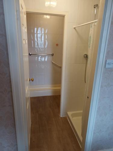 a bathroom with a shower and a bath tub at Eden Vale Ground Floor Sea View Apartment in Morecambe