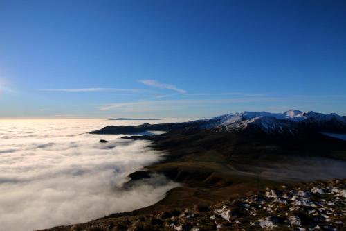 a view from the top of a mountain above the clouds at L'Esprit du Bois in Aydat