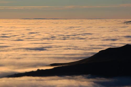 a view from above a sea of clouds at L'Esprit du Bois in Aydat