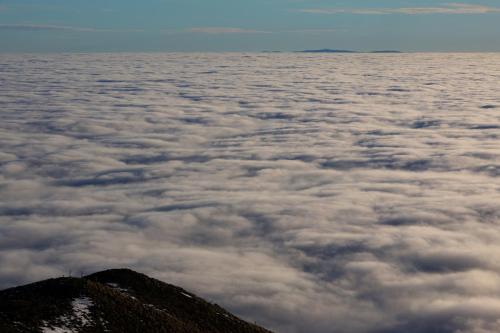 a view of clouds from the top of a mountain at L'Esprit du Bois in Aydat