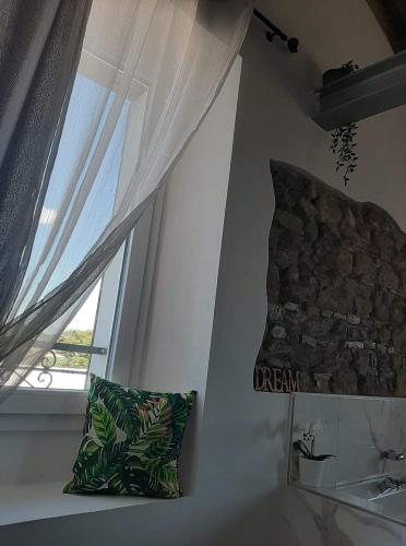 a room with a window and a pillow and a sink at Sogno Proibito in Meldola