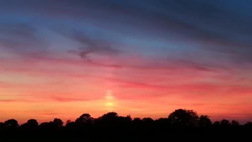 a sunset with the sun in the sky at Lilac Manor in Sligo