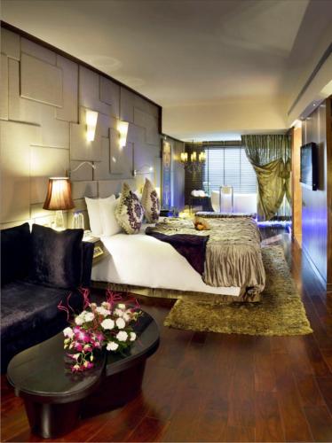 a bedroom with a large bed and a couch at Radisson Blu Hotel MBD Ludhiana in Ludhiana