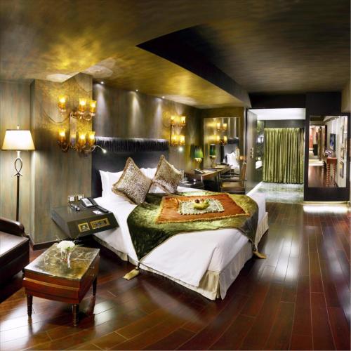 a bedroom with a large bed and a living room at Radisson Blu Hotel MBD Ludhiana in Ludhiana