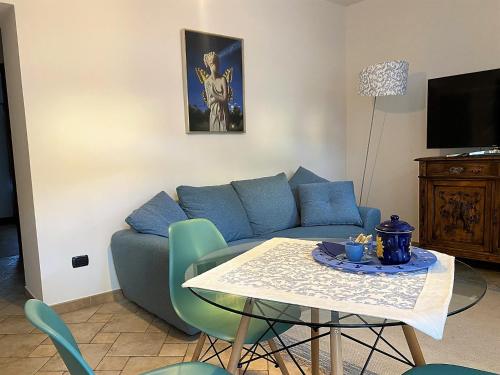 a living room with a blue couch and a table at Il Ciapiné in Giaveno