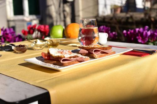 a plate of sandwiches on a table with a glass at New W Hotel in Tirana