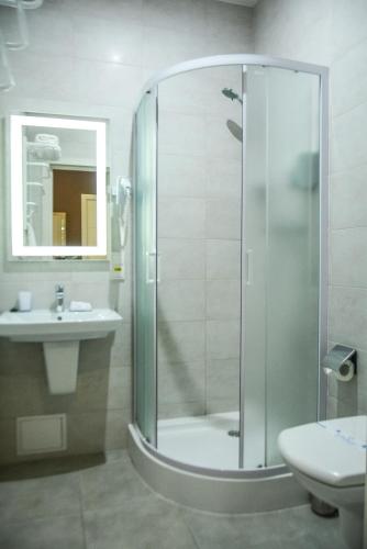 a bathroom with a shower and a sink at Hotel Voskresensky in Sumy