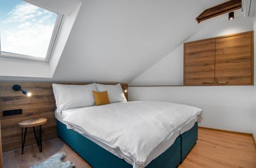 a small bedroom with a bed and a window at Vista Apartments in Kutná Hora