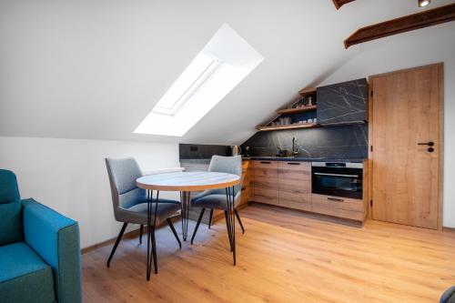 a kitchen and dining room with a table and chairs at Vista Apartments in Kutná Hora