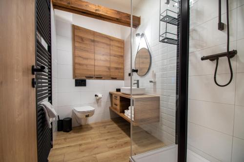 a bathroom with a shower and a toilet and a sink at Vista Apartments in Kutná Hora