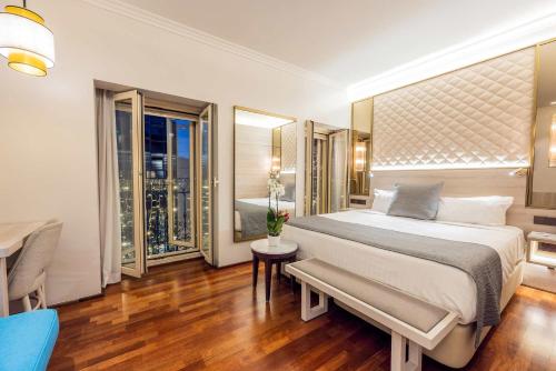 a bedroom with a large bed and a table and chairs at Preciados in Madrid