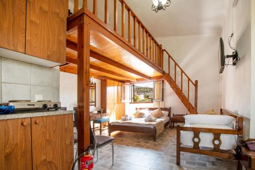 a kitchen with a staircase and a living room at Villa Medusa in Hersonissos