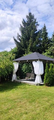 a gazebo with an umbrella in a yard at Dom Skandynawski Sen in Wałcz