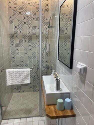 a bathroom with a sink and a shower at DayBreak 2 in Taitung City
