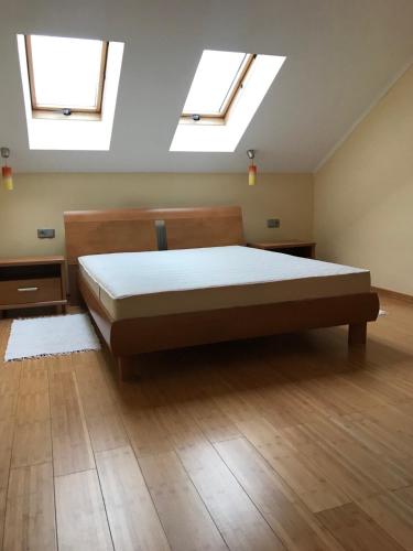 a bedroom with a bed with two skylights at Затишна квартира в спальному районі in Lviv
