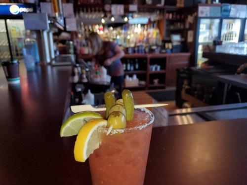 a drink with lemons and lime slices on a bar at Buffalo Lodge of Bigfork in Bigfork