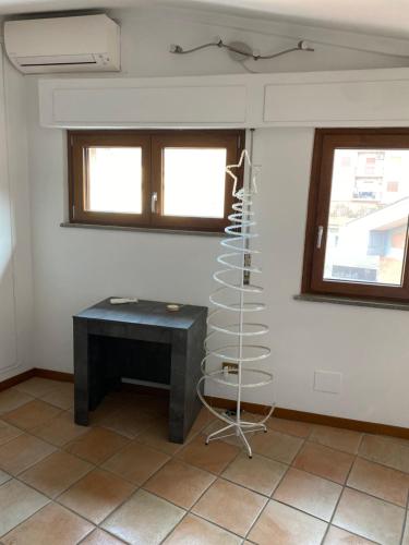 a room with a black desk and two windows at Frascati Roof 2 in Frascati