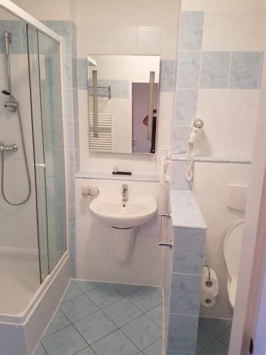 a white bathroom with a sink and a shower at Wellness & SPA Lipno - Frymburk C410 in Frymburk